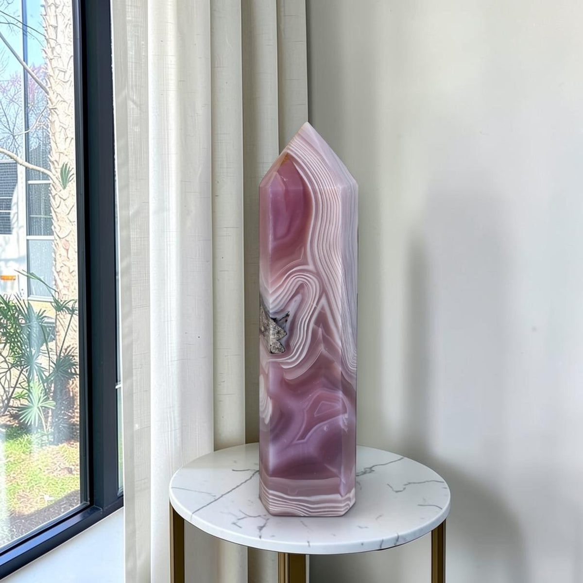 Tall pink-purple agate crystal tower with layered stripes and druzy pocket