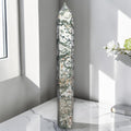 Moss agate obelisk point, tall green-and-white stone with dark veining.