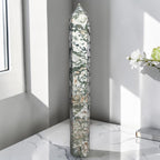 Moss agate obelisk point, tall green-and-white stone with dark veining.