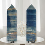 Pair of blue stone crystal obelisks with pointed tops and banded striped patterns