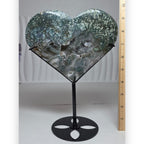 Large moss agate druzy heart on black metal stand, front view showing green and teal tones