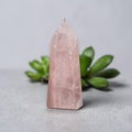Rose quartz crystal tower, light pink faceted point with smooth base