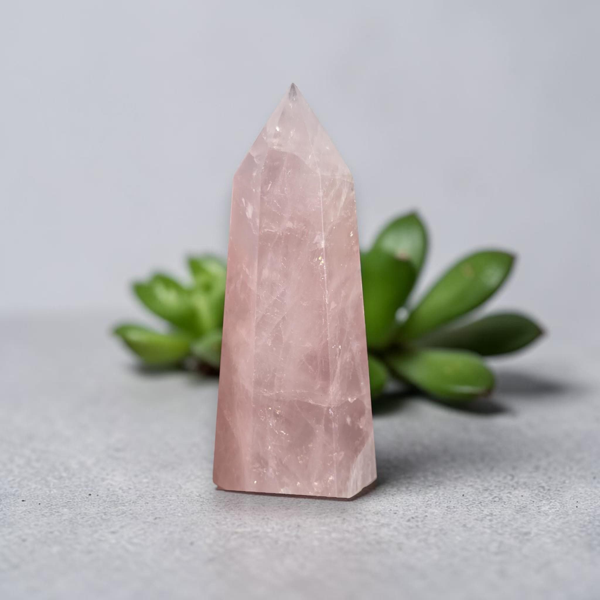 Rose quartz crystal tower, light pink faceted point with smooth base