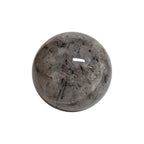 Polished quartz sphere with black needle inclusions and glassy highlight, 66mm