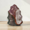 Flame-shaped jasper crystal sculpture with purple and dark green sections