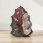 Flame-shaped jasper crystal sculpture with purple and dark green sections