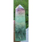 Rainbow fluorite crystal tower close-up, green body and purple cap on pointed top