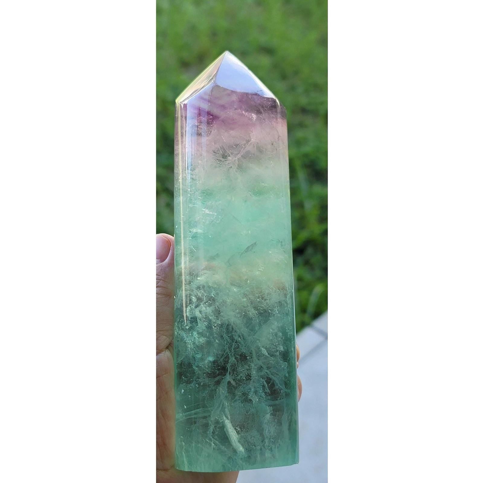 Rainbow fluorite crystal tower close-up, green body and purple cap on pointed top