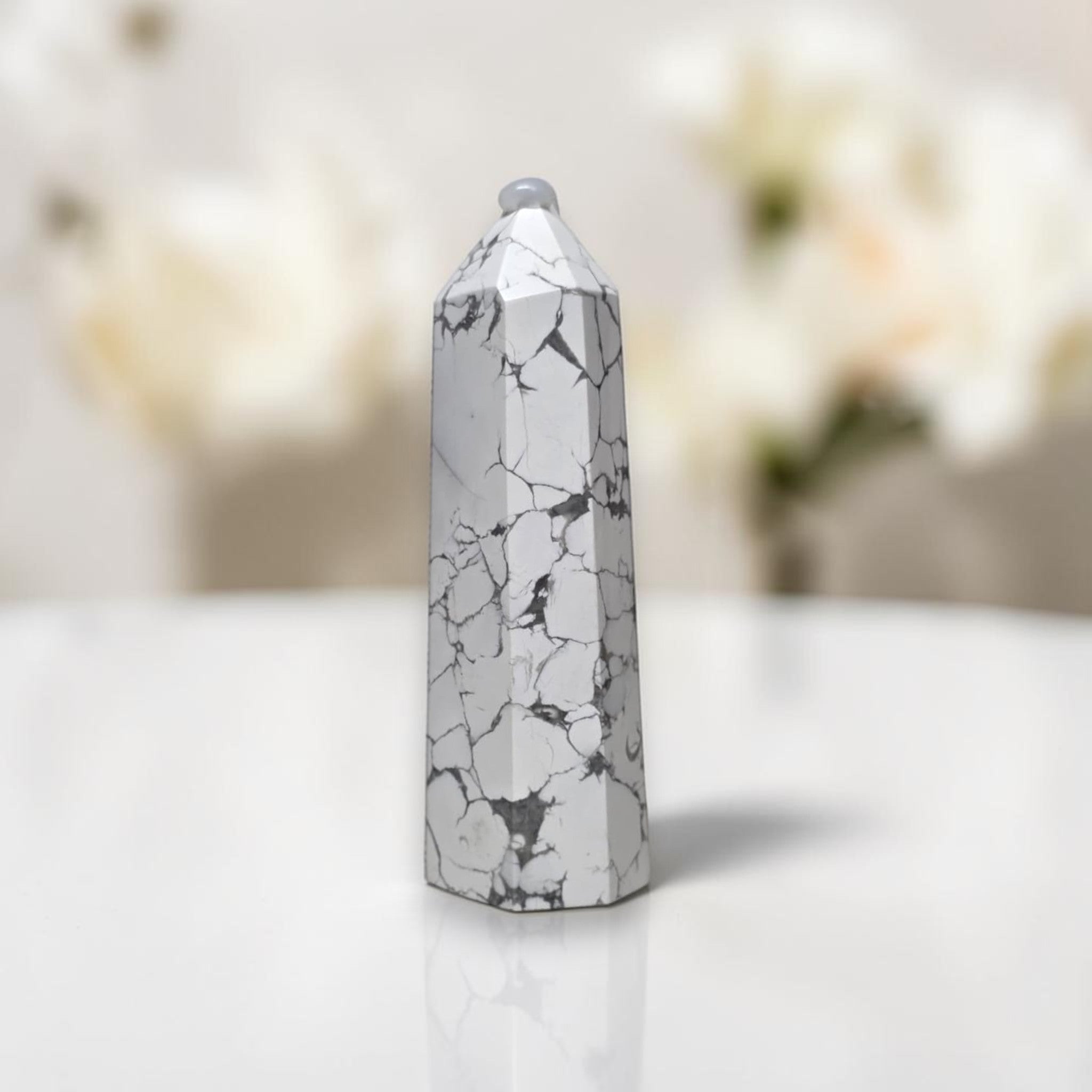 White howlite tower with gray veining, faceted pointed top