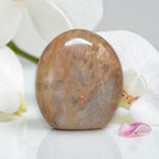 Polished peach moonstone crystal, freeform rounded dome with white veining