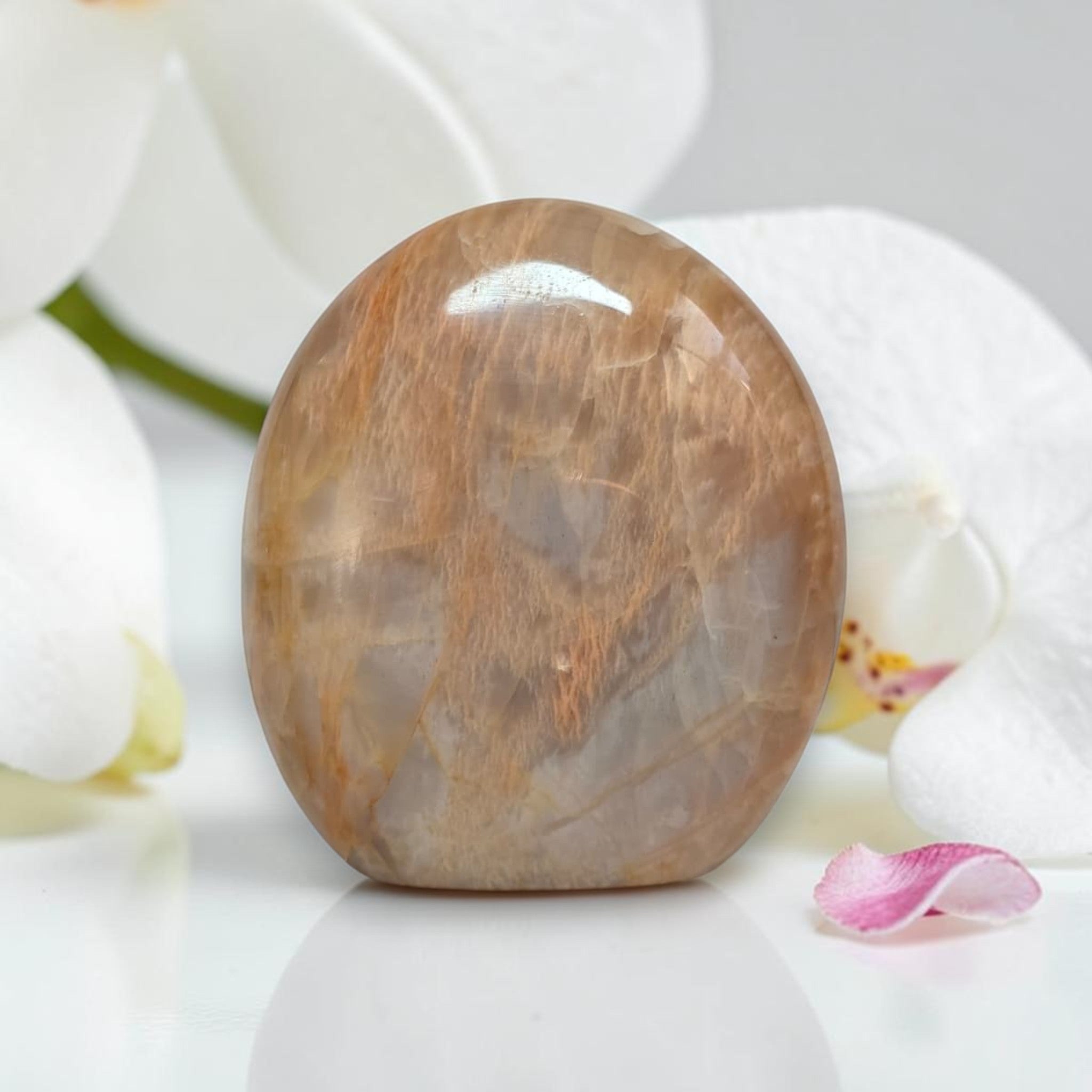 Polished peach moonstone crystal, freeform rounded dome with white veining