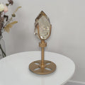 Smoky quartz crystal on rotating gold pedestal stand with faceted smoky-clear top