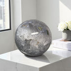Moss agate geode sphere: dark gray-blue with white druzy center and small green specks