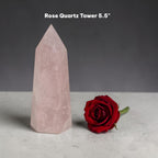 Light pink rose quartz crystal tower with sharp pointed tip and flat base