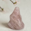 Rose quartz flame-shaped crystal, pink translucent with natural veining and facets