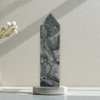 Moss agate crystal obelisk with pointed top, mottled gray stone with green streaks