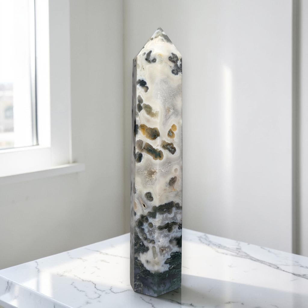 Natural crystal obelisk tower with white base and dark green speckles, pointed top