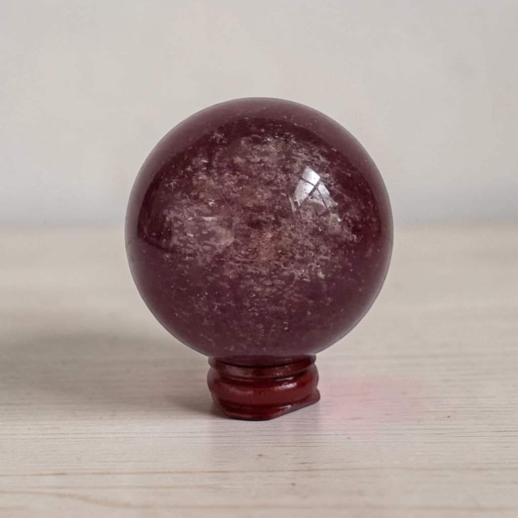 Deep red crystal sphere with glossy finish on red base