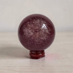 Deep red crystal sphere with glossy finish on red base