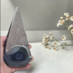Smoky druzy agate obelisk tower held in hand; sparkly purple top, banded base