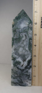 Moss agate obelisk with pointed top beside measuring ruler; green, gray and white bands