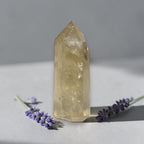 Citrine quartz tower with faceted, translucent pale yellow crystal point