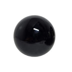 Black obsidian sphere with rounded shape and smooth mirror-like sheen