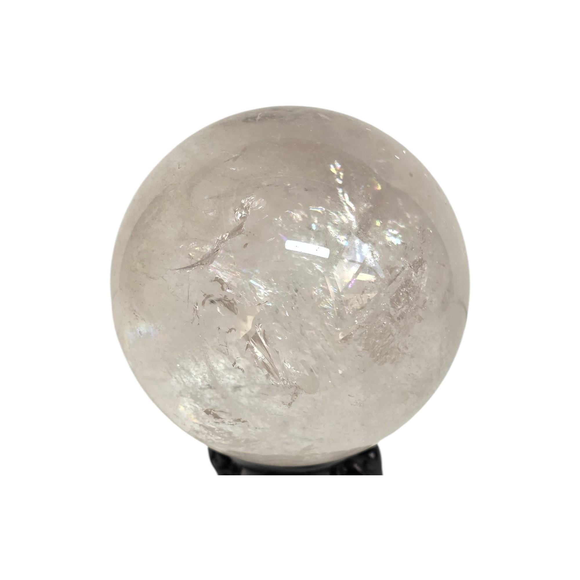 Polished clear quartz sphere gemstone with glossy surface and visible light crystal inclusions