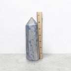 Blue speckled crystal tower with pointed top and flat faceted sides