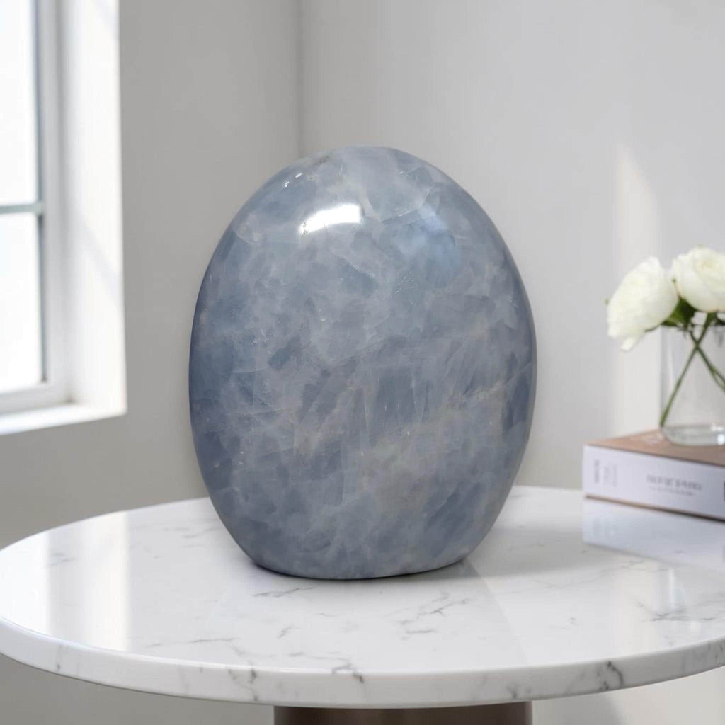Blue calcite freeform stone sculpture, rounded upright oval with glossy surface
