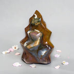 Polished flame-shaped jasper stone, golden amber with dark gray-blue and maroon flecks