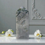 Moss agate crystal obelisk, tall translucent white stone with green mineral specks and druzy.