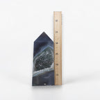Geode crystal with a ruler for scale on a white background