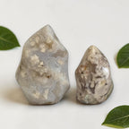 Set of 2 agate flame crystals: one tall and one small, clear beige with white inclusions