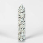 Tall polished jasper obelisk with pointed top, speckled pattern on light stone.