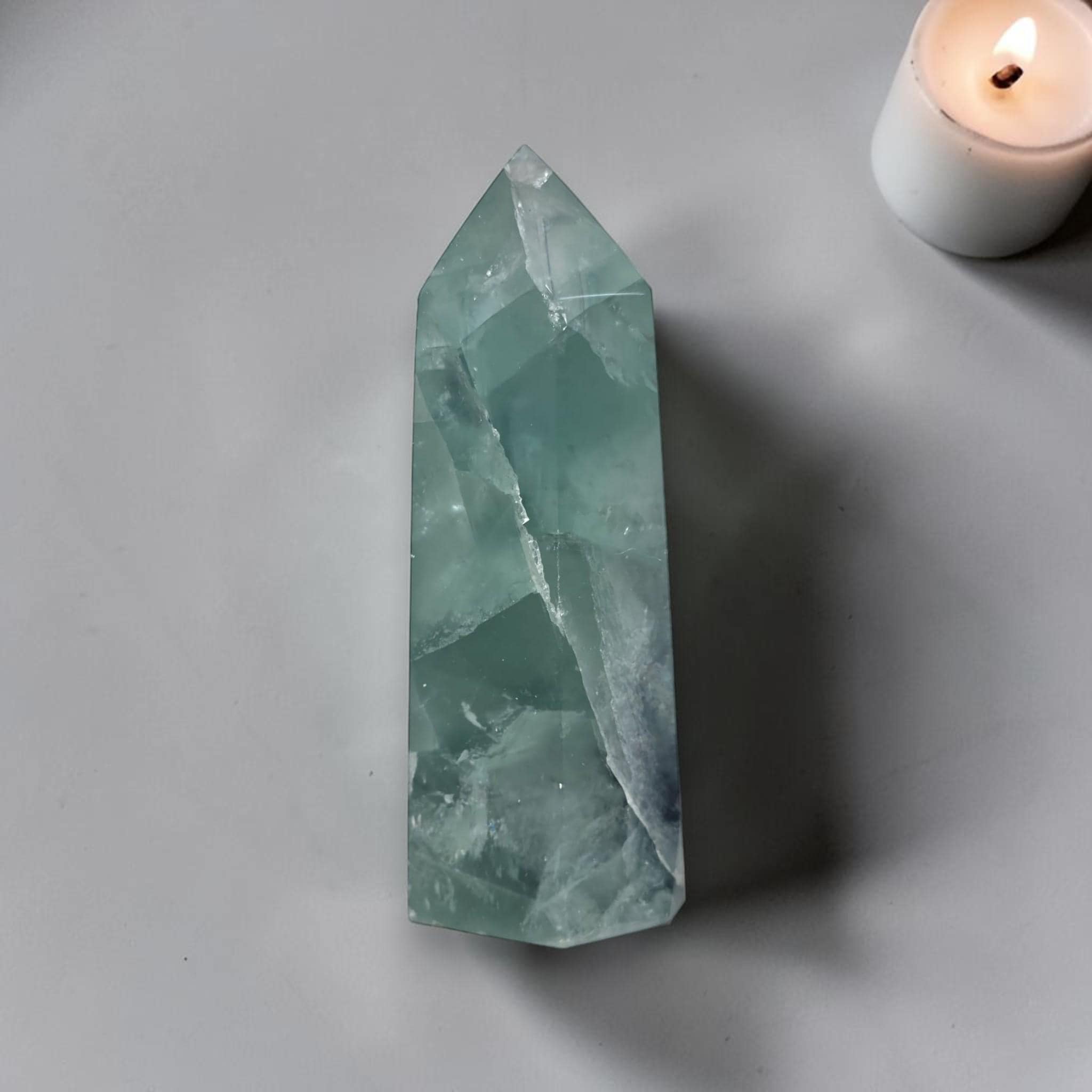 Fluorite crystal tower with pointed top, translucent teal green with angular facets