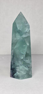 Fluorite crystal tower with pointed top, clear mint green facets with natural striations