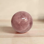 Rose quartz sphere, 73mm, polished pink translucent crystal with natural inclusions
