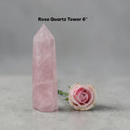 Rose quartz crystal tower in pale pink, angular point with polished sides