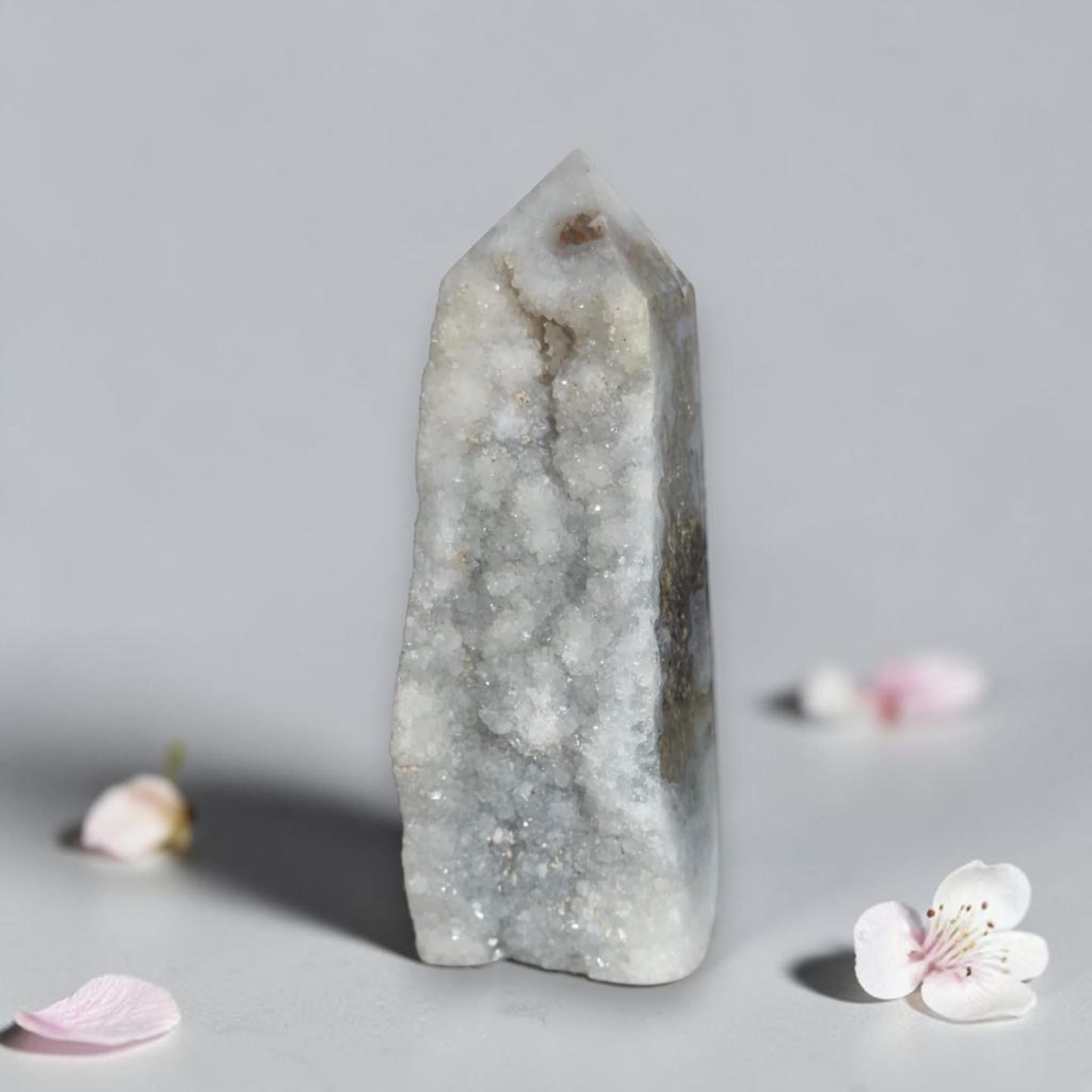 Agate drusy crystal tower with pointed top, white-gray with faint mossy green mineral spots.