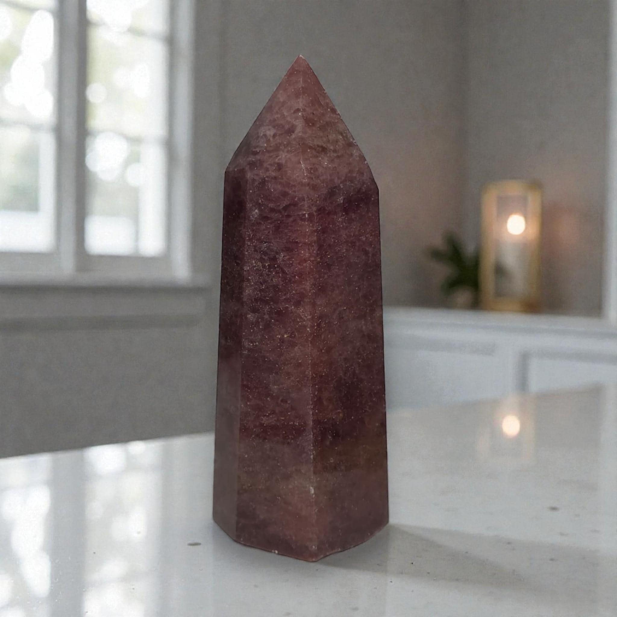 Deep red crystal point tower decor with faceted, pointed top