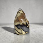Polished agate flame-shaped stone decor with yellow-brown areas and dark gray base