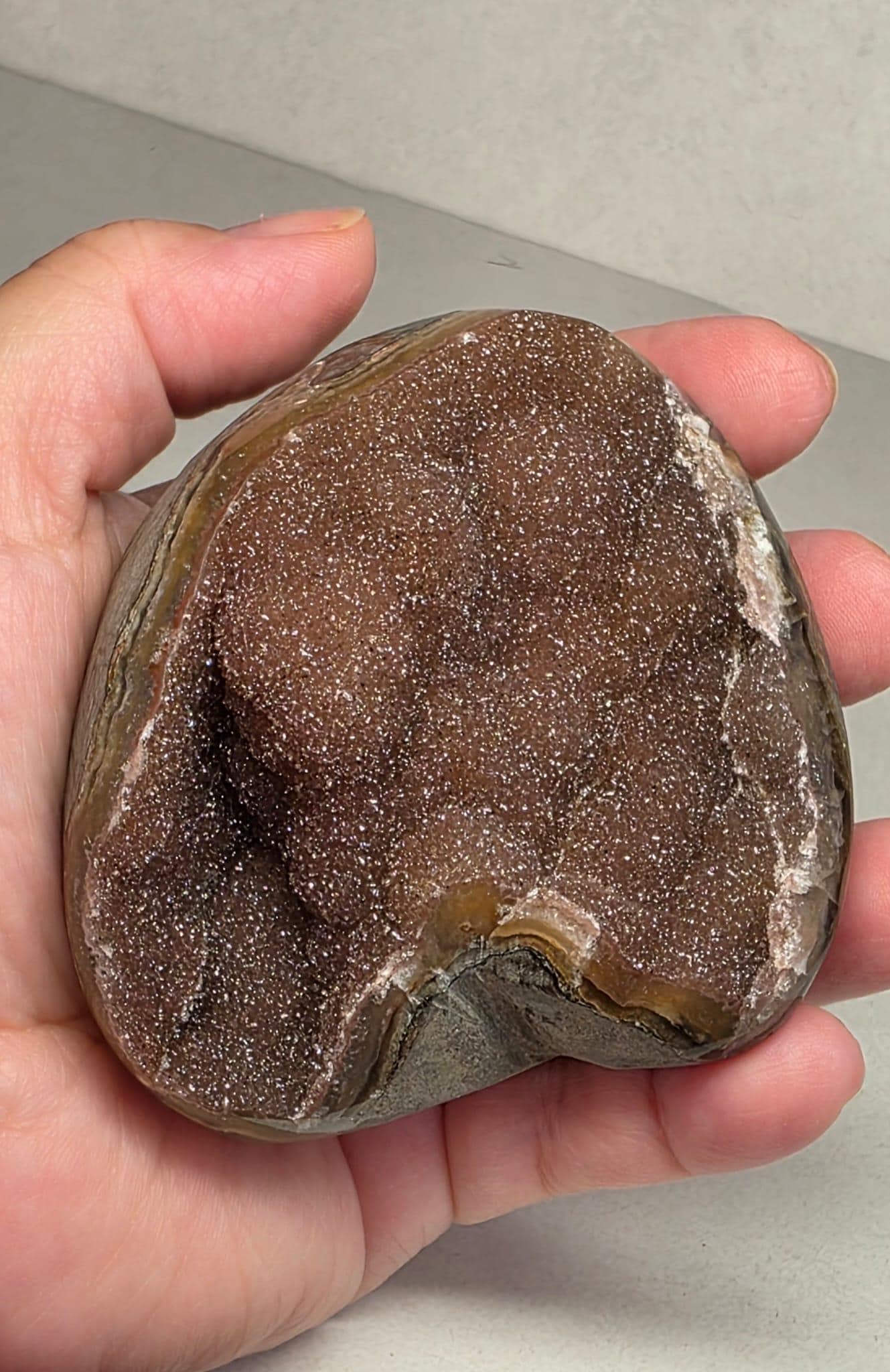 Amethyst quartz druzy freeform stone, close view of dark purple glittered surface.