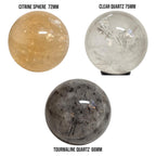 Set of three polished gemstone spheres: citrine, clear quartz, and tourmaline quartz