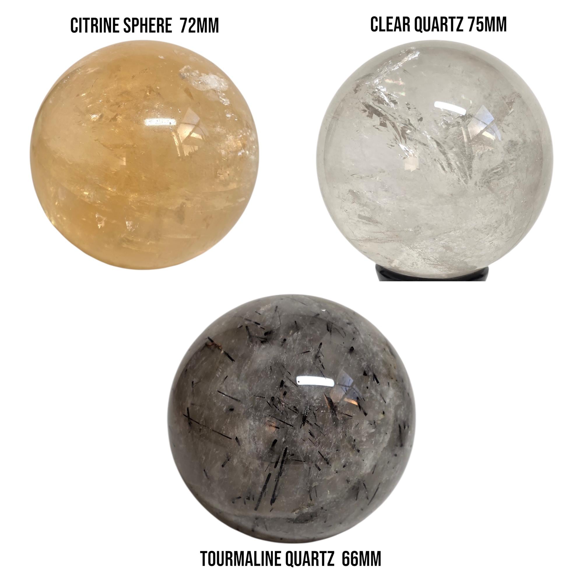 Set of three polished gemstone spheres: citrine, clear quartz, and tourmaline quartz