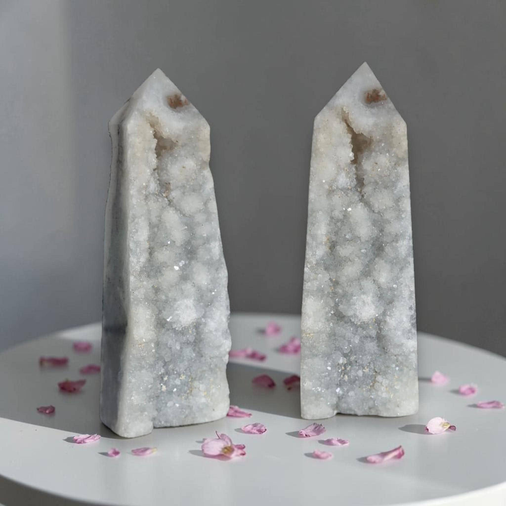 Pair of agate drusy crystal towers with pointed tops, white-gray sparkly crystals; rounded bases.