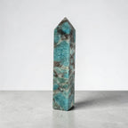 Blue-green mineral obelisk point, tall rectangular prism shape with sharp tip