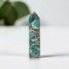 Blue-green mineral obelisk point, narrow tower shape with faceted pointed top
