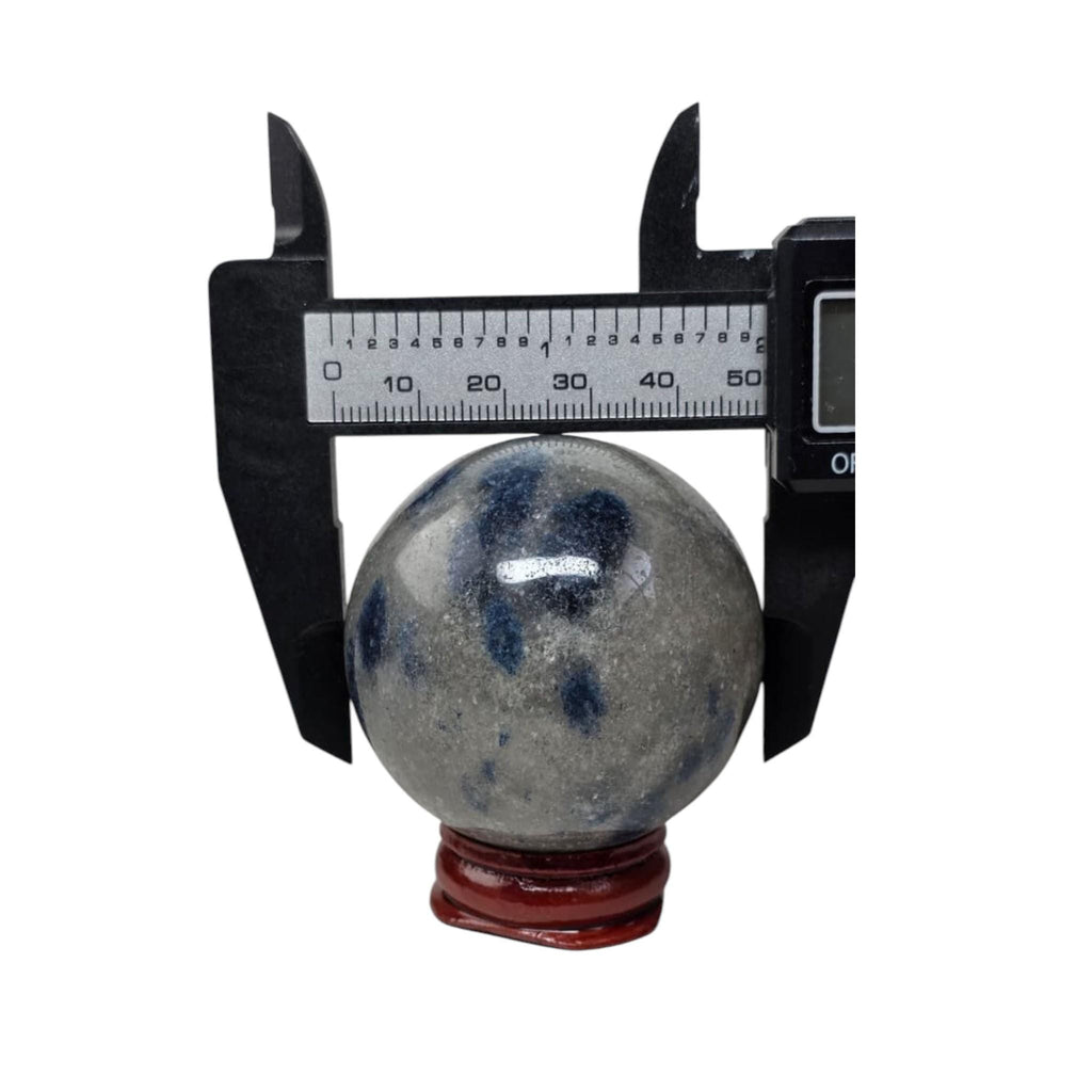 Granite crystal sphere with blue mottling, caliper measurement, on red stand