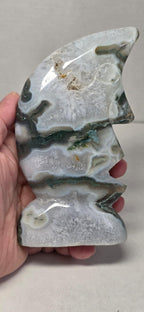 Moon face carving in moss agate, light gray with green veining, carved facial features